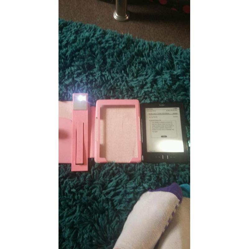 Amazon Kindle with pink case and light
