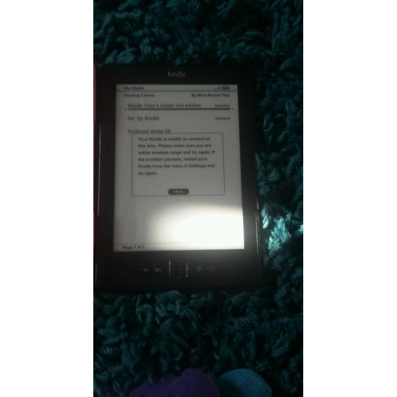 Amazon Kindle with pink case and light