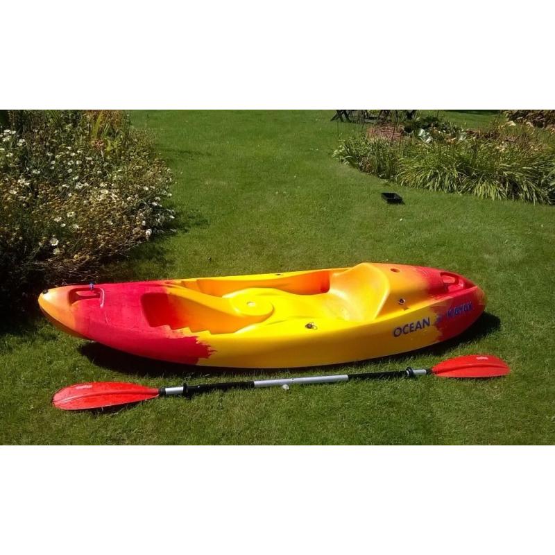 Single person sit on top ocean kayak with free paddle