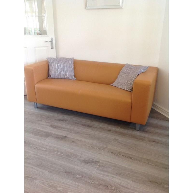 Two tan leather effect sofas